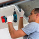 Man screwing into plasterboard